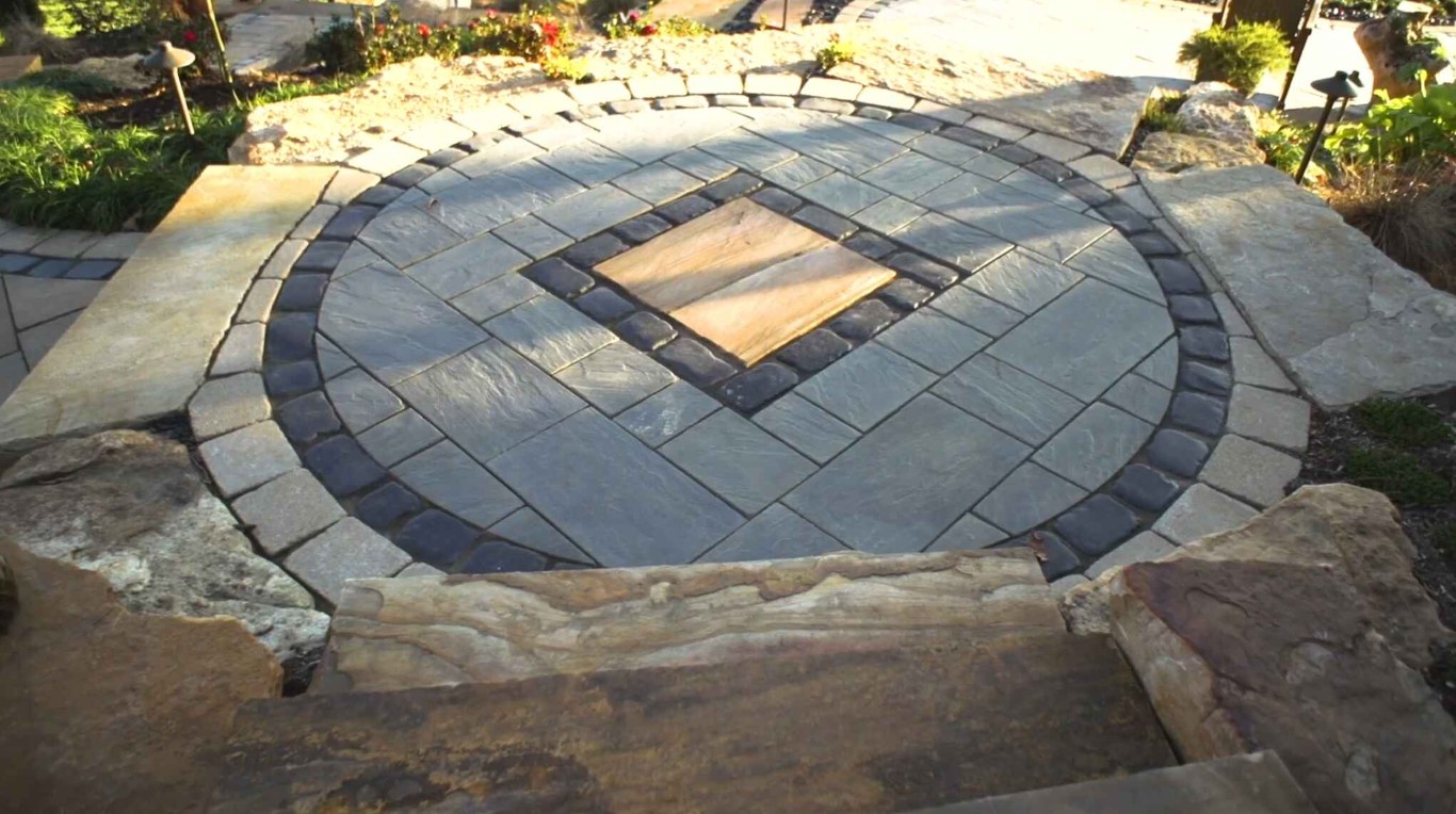 Circular paver patio with fire pit and natural stone borders in Stanton, CA